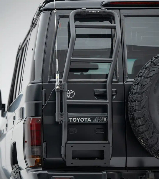 Back of a Toyota vehicle with a ladder rack on a cloudy day