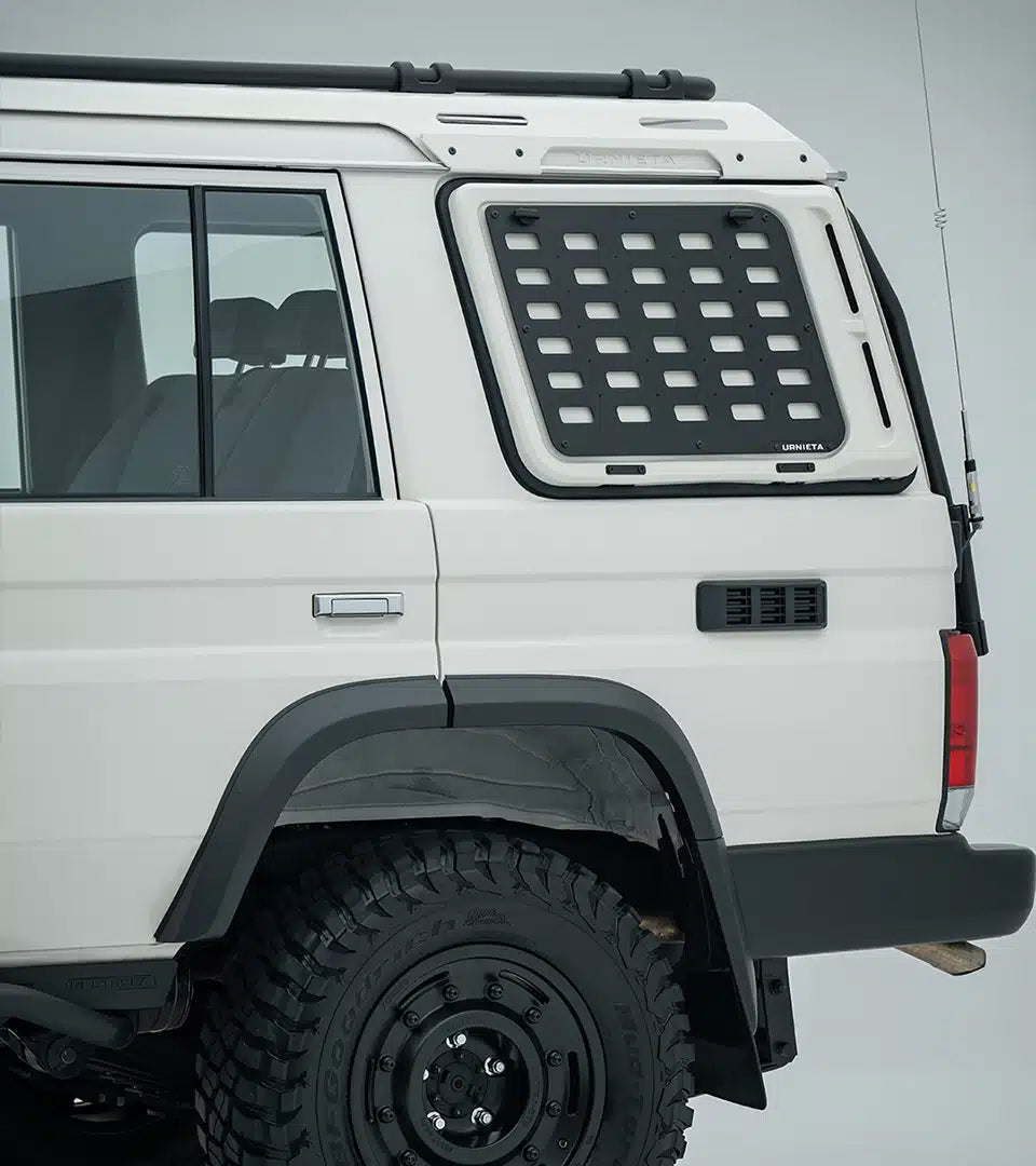 White off-road vehicle with a roof rack and additional storage compartment on a gray background