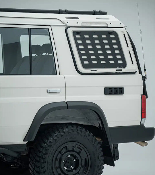 White off-road vehicle with a roof rack and additional storage compartment on a gray background