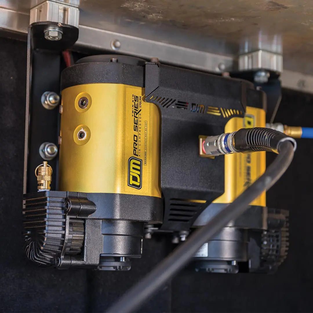 Close-up of a yellow and black pressure washer with visible branding on a dark background